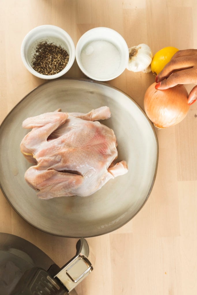 Raw whole chicken for the Best Rotisserie Chicken Recipe.