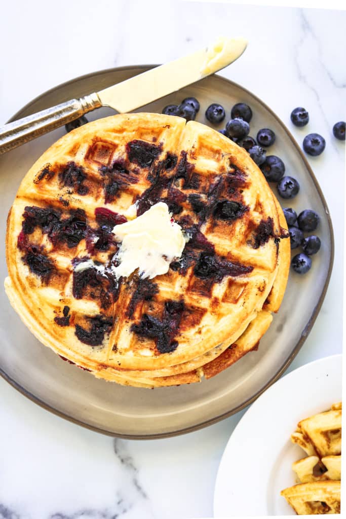 Blueberry waffles on a plate.